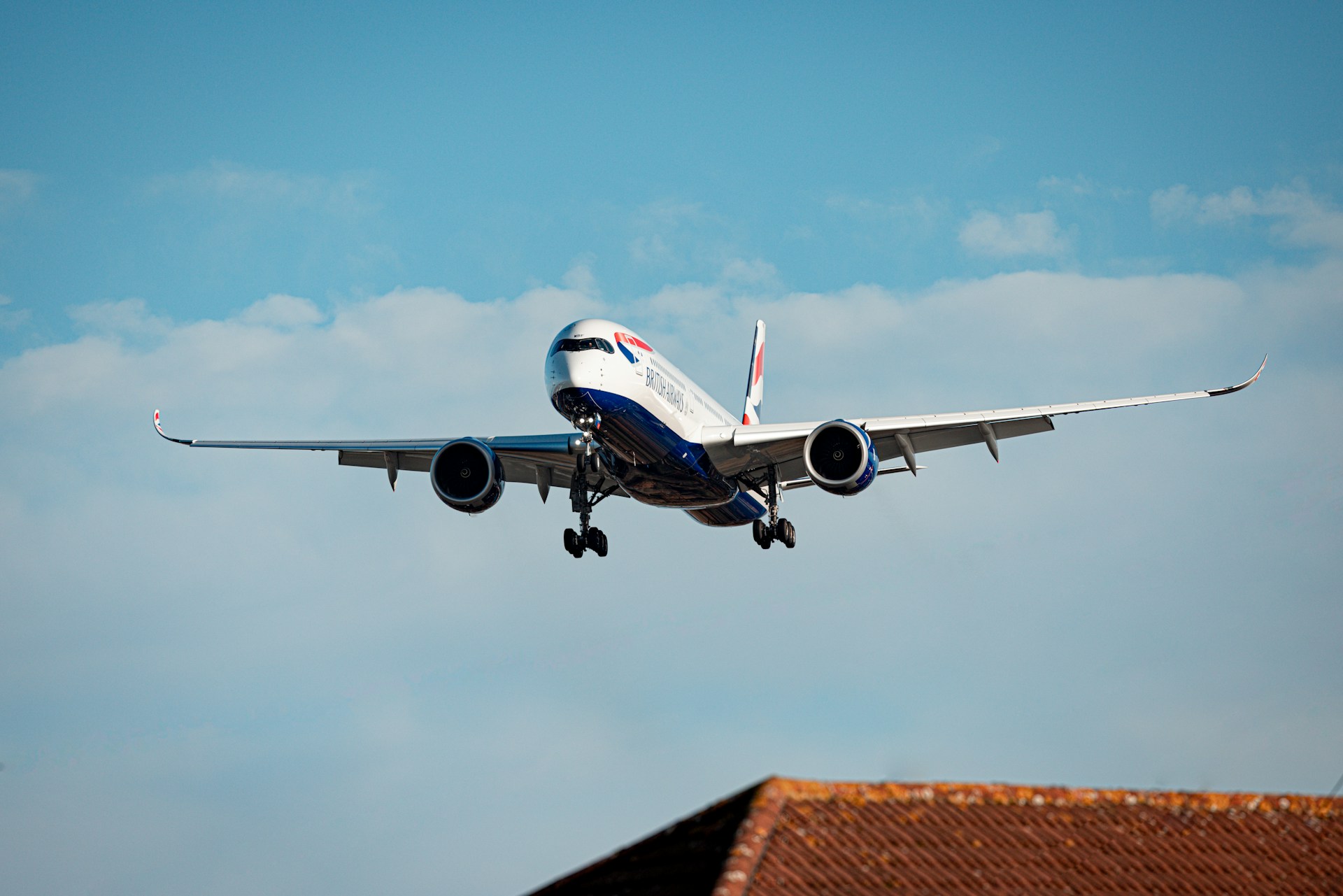A British Airways flight above a roof